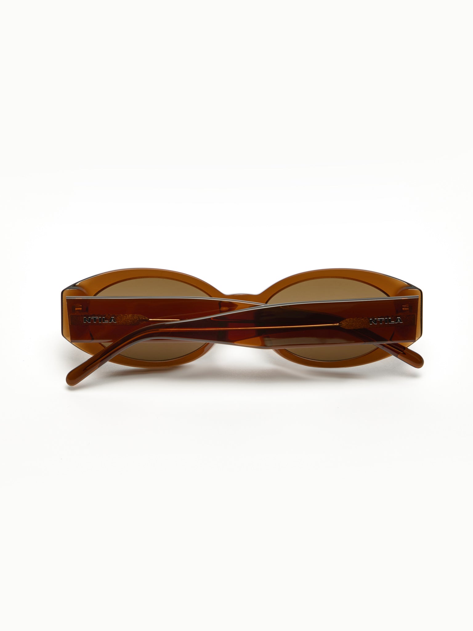 Cleo brown oval sunglasses on a white background